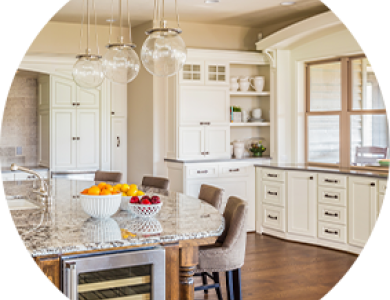 A kitchen with white cabinets in a daytime setting.