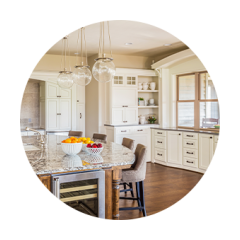 A kitchen with white cabinets in a daytime setting.