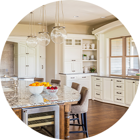 A kitchen with white cabinets in a daytime setting.