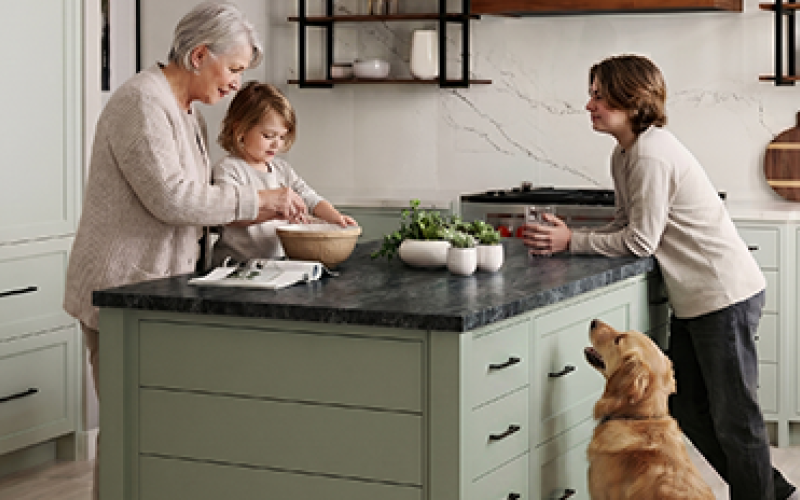 A family baking together around an island made of quality cabinets.